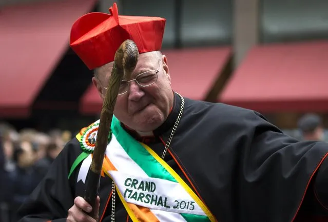 Cardinal Timothy Dolan, Archbishop of the Archdiocese of New York winks to spectators as he marches as the Grand Marshall of the 254th New York City St. Patrick's Day parade up 5th Avenue in the Manhattan Borough of New York, March 17, 2015. (Photo by Mike Segar/Reuters)