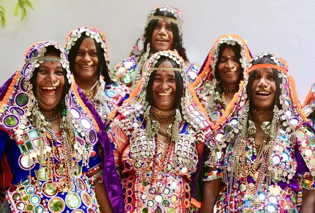 Banjara tribal women wearing colourful “ghaghra” and “choli” (a blouse) pose for photos before cultural event in Bangalore, India, 04 October 2023. Banjara's tribal people are innumerable nomadic tribes are found in Andhra Pradesh, Bihar, Madhya Pradesh, Himachal Pradesh, Gujarat, Tamil Nadu, Maharashtra, Karnataka, Odisha and West Bengal wandering from one place to another. Over hundreds of Banjara community tribal people gathered to discuss various issues regarding economic, education, social and political status in the society. (Photo by Jagadeesh N.V./EPA/EFE)