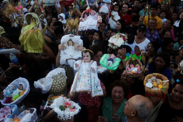 Catholic faithfuls hold figurines of baby Jesus during a religious procession on Holy Innocents Day in Antiguo Cuscatlan, El Salvador, December 28, 2016. (Photo by Jose Cabezas/Reuters)