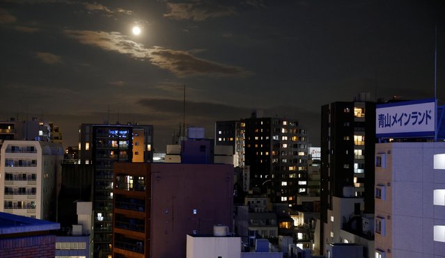 The full moon is pictured over a neighborhood in Tokyo, Japan on June 24, 2021. (Photo by Fabrizio Bensch/Reuters)