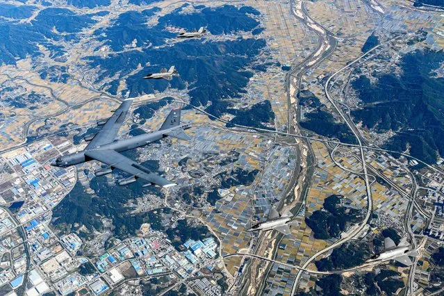 This handout photo taken on October 17, 2023 and provided by the South Korean Defence Ministry shows a US Air Force B-52H strategic bomber (C) flying with South Korean Air Force F-35A fighter jets during a joint air drill in South Korea. (Photo by South Korean Defence Ministry/Handout via AFP Photo)