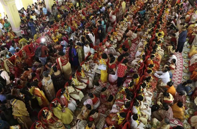 Young Hindu girls sit together for a ceremony where they are worshipped as “Kumari”, or living goddess, during Ram Navami festival, at a temple in Kolkata, India, Saturday, March 28, 2015. (Photo by Bikas Das/AP Photo)