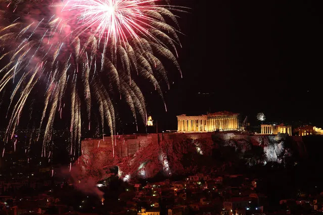 Fireworks illuminate the sky over the ancient Parthenon temple on the Acropolis Hill in Athens, Greece, for the celebrations of the New Year, 01 January 2017. (Photo by Simela Pantzartzi/EPA)