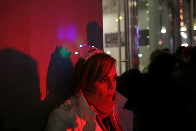 A reveler waits in long lines to enter Times Square in preparation for the New Year's celebration in Manhattan, New York City, U.S., December 31, 2016. (Photo by Stephen Yang/Reuters)
