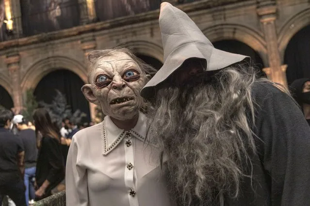 Fans of the Lord of the Rings cosplay as Golum and Gandalf during “The Lord Of The Rings: The Rings Of Power” red carpet at Colegio Vizcainas on August 17, 2022 in Mexico City, Mexico. (Photo by Cristopher Rogel Blanquet/Getty Images)