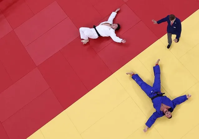 Czech Republic's Lukas Krpalek (blue) celebrates his victory over Japan's Hisayoshi Harasawa at the end of their judo men's +100kg semifinal bout during the Tokyo 2020 Olympic Games at the Nippon Budokan in Tokyo on July 30, 2021. (Photo by Sergio Perez/Reuters)