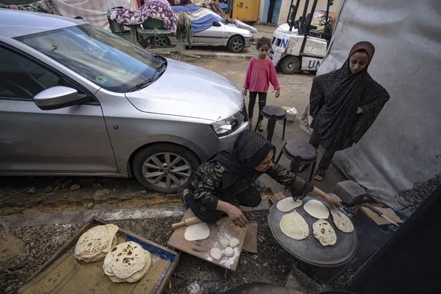 Palestinians displaced by the Israeli bombardment of the Gaza Strip prepare bread in a UNDP-provided tent camp in Khan Younis, Wednesday, November15, 2023. (Photo by Fatima Shbair/AP Photo)