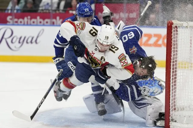 Florida Panthers left wing Matthew Tkachuk (19) crashes into Toronto Maple Leafs goaltender Joseph Woll (60) as Leafs' Matthew Knies defends during the third period of an NHL hockey game in Toronto on Tuesday, November 28, 2023. (Photo by Frank Gunn/The Canadian Press via AP Photo)