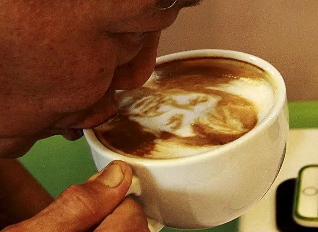 A man sips a cup of coffee with latte art depicting a caricature of Filipino World Boxing Champion (WBC) Manny Pacquiao at Bunny Baker cafe in Manila April 9, 2015. (Photo by Romeo Ranoco/Reuters)