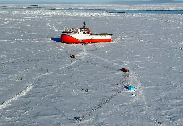Russian scientific vessel Severny Polyus is seen caught in the arctic ice some 440km south of the north pole on June 6, 2023. A Russian national onboard the ship was evacuated at the request of their Russian counterparts. The Norwegian authorities launched a Super Puma helicopter from Longyearbyen, the main town of Svalbard, 500 nautical miles (925 km) away, to evacuate the Russian, whose state of health has was deemed too critical to be treated on board ship. “It's at the extreme limit of what the helicopter can do” in terms of range, spokesman for the Norwegian Rescue Center in Bodo, Rune Danielsen, told AFP. (Photo by Sysselmesteren Svalbard/AFP Photo)
