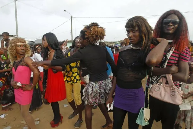 Men dressed as women take part in a parade during the Popo (Mask) Carnival of Bonoua, in the east of Abidjan, April 18, 2015. (Photo by Luc Gnago/Reuters)