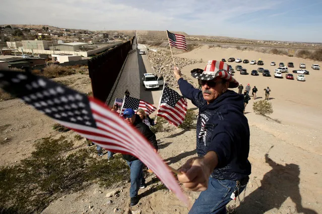 U.S demonstrators hold U.S flags at the open border to make a human wall in support of the construction of the new border wall between U.S and Mexico in Ciudad Juarez, Mexico February 9, 2019. (Photo by Jose Luis Gonzalez/Reuters)