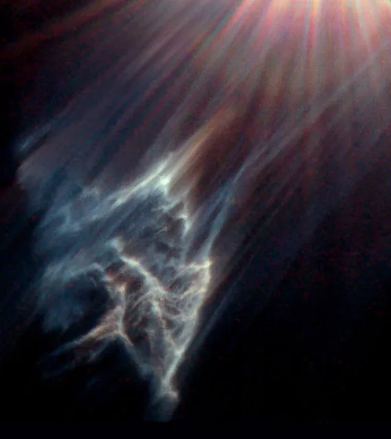 This image made by the NASA/ESA Hubble Space Telescope shows the tendrils of a dark interstellar cloud being destroyed by the passage of one of the brightest stars in the Pleiades star cluster. (Photo by NASA/ESA, Hubble Heritage Team STScI/AURA, George Herbig via AP Photo)
