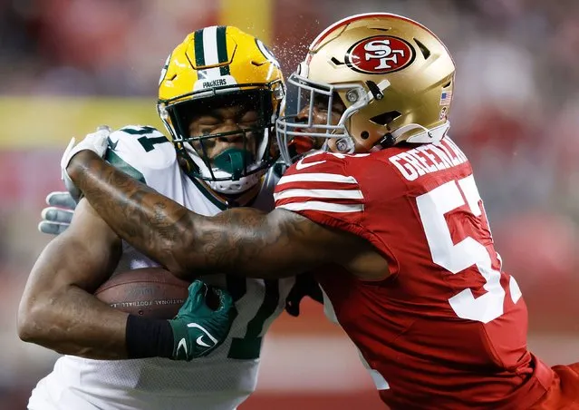 Dre Greenlaw #57 of the San Francisco 49ers tackles Emanuel Wilson #31 of the Green Bay Packers during the first half in the NFC Divisional Playoffs at Levi's Stadium on January 20, 2024 in Santa Clara, California. (Photo by Lachlan Cunningham/Getty Images)
