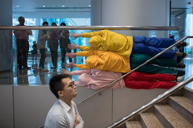 Dancers perform as human sculptures during an exhibition in Hong Kong, China, 26 March 2019. (Photo by Jerome Favre/EPA/EFE)