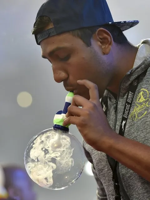 Miraj Patel of Florida, blows vapor inside a bubble at the Vape Summit 3 in Las Vegas, Nevada May 2, 2015. (Photo by David Becker/Reuters)