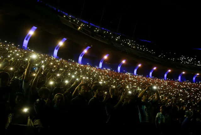 Racing Club fans light flares in the stands during a local tournament soccer match in Buenos Aires, Argentina, Sunday, April 7, 2019. Racing Club, one of the five giants of Argentinian soccer, won its ninth national league trophy last weekend after a 1-1 draw against another team, Tigre. (Photo by Agustin Marcarian/Reuters)