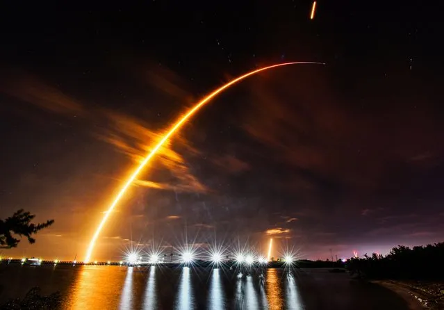 A SpaceX Falcon 9 rocket is launched from a pad at the Kennedy Space Center, seen from Port Canaveral in Florida, US on February 15, 2024. (Photo by Malcolm Denemark/AP Photo)