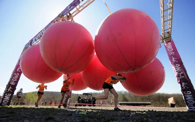 Participants race through an obstacle on Saturday, May 2, 2015 during the Dirty Girl Mud Run at Montage Mountain in Scranton, Pa. (Photo by Butch Comegys/The Scranton Times-Tribune via AP Photo)