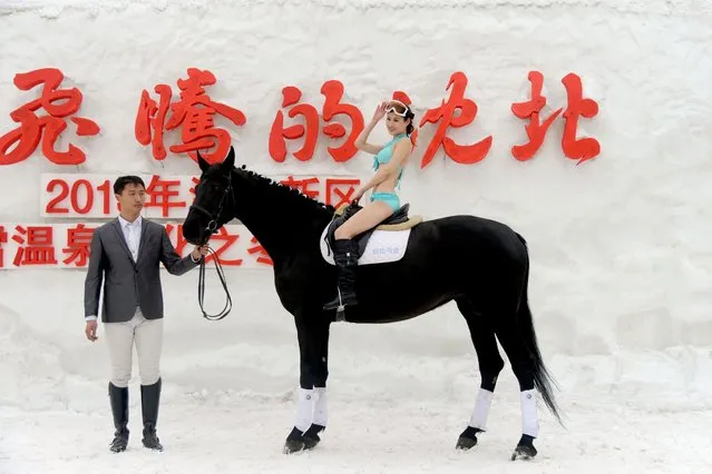 This picture taken on February 15, 2014 shows a model in bikini posing on a horse for a beauty contest to promote a ski resort in Shenyang, northeast China's Liaoning province. From just 300,000 tourist arrivals in 1978, the number of foreign visitors to China, according to the UNWTO Tourism Highlight 2013 Edition, is ranked the third most popular tourist destination in the world, with a total of 58 million international tourists visiting the country in 2012. (Photo by AFP Photo)
