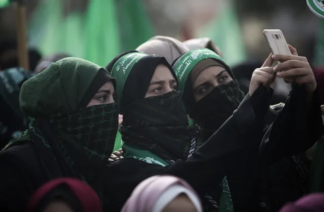 Women photograph take a selfie during a Hamas mass Rally marking the 31 anniversary of its founding, in Gaza City Sunday, December 16, 2018, in Gaza city. (Photo by Khalil Hamra/AP Photo)