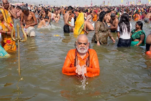 A Hindu devotee prays as he takes a holy dip at the Sangam, the confluence of three rivers – the Ganges, the Yamuna and the mythical Saraswati, on Maghi Purnima or the full-moon day at the annual traditional fair in Prayagraj, in the northern Indian state of Uttar Pradesh, India,Saturday, February 24, 2024. (Photo by Rajesh Kumar Singh/AP Photo)