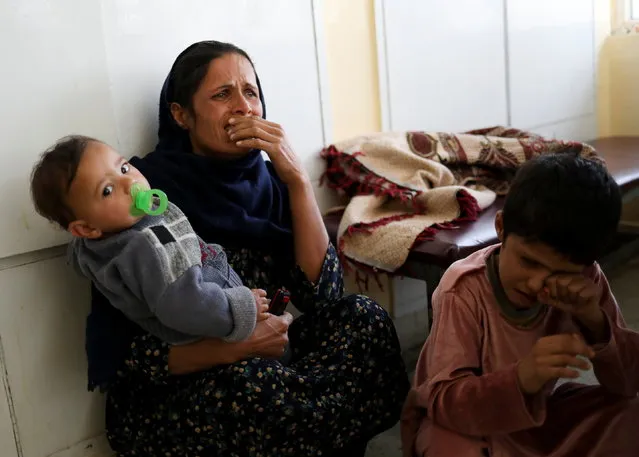 An Afghan woman reacts at the Indira Gandhi Children's hospital after explosions at a military hospital in Kabul, Afghanistan on November 2, 2021. Indira Gandhi Children's hospital was not attacked. (Photo by Ali Khara/Reuters)