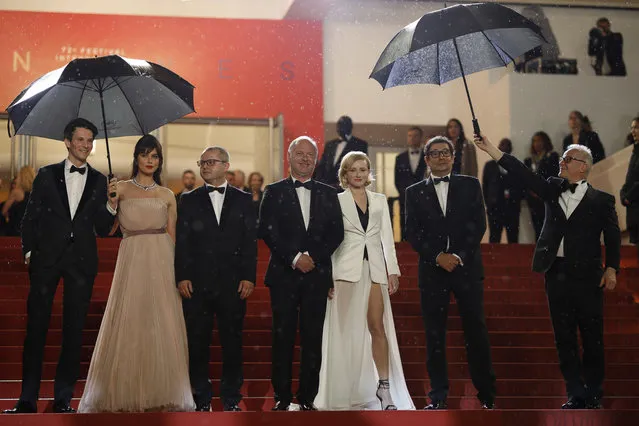 In this Saturday, May 18, 2019 photo actors Sabin Tambrea, Catrinel Marlon, director Corneliu Porumboiu, actors Vlad Ivanov, Rodica Lazar, Agusti Villaronga and Cannes film festival president Thierry Fremaux pose for photographers upon arrival at the premiere of the film “The Whistlers” at the 72nd international film festival, Cannes, southern France. (Photo by Petros Giannakouris/AP Photo)