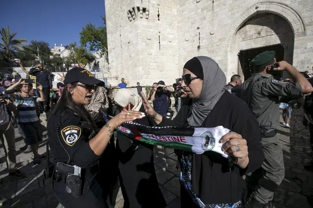 A Palestinian protester (R) gestures in front of an Israeli police officer near Damascus Gate outside Jerusalem's Old City during a march marking Jerusalem Day May 17, 2015. Israeli police on horseback confronted dozens of Palestinian protesters who threw stones at the forces protecting thousands of flag-waving Jewish nationalists marching on Sunday on the anniversary of Israel's capture of East Jerusalem in a 1967 war. (Photo by Baz Ratner/Reuters)