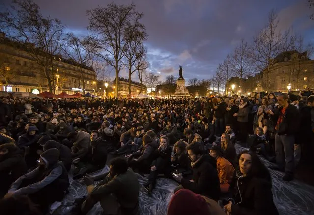 Participants of the social media-born movement dubbed “La Nuit Debout” (The Night awake or The night standing up) take part in a general assembly sit-in on Place de la Republique, to protest against the labor law reform bill in Paris, France, 09 April 2016. The Nuit Debout movement, which began on 30 March 2016, is reminiscent of the Spanish “Podemos” movement and the global “#Occupy” movement – with daily general assemblies organised at sun-down. (Photo by Ian Langsdon/EPA)