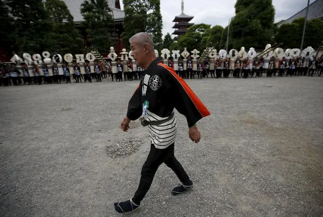 A man wearing a traditional firefighters' happi coat attends a memorial service for  firefighters at Sensoji temple in Tokyo's downtown of Asakusa May 25, 2015. (Photo by Issei Kato/Reuters)