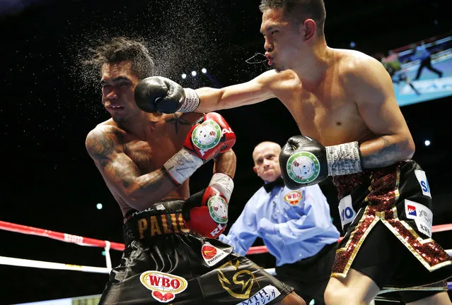 Japan's Kazuto Ioka, right, sends a right to Philippines' Aston Palikute in the 10th round of their WBO super flyweight boxing title match in Makuhari, near Tokyo, Wednesday, June 19, 2019. Ioka clinched the title by a technical knockout in the round. (Photo by Toru Takahashi/AP Photo)