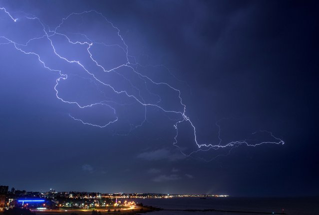 Lightning strikes across the sky during a thunderstorm in Montevideo early on November 18, 2023. (Photo by Mariana Suarez/AFP Photo)