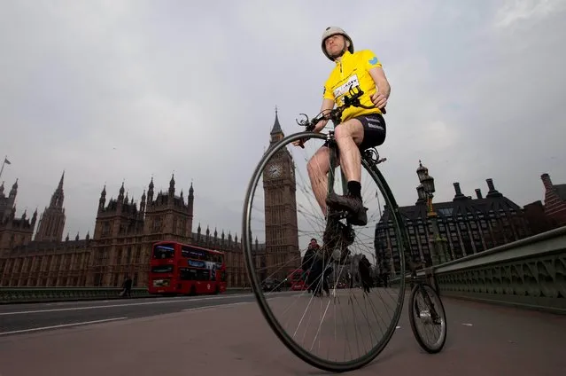 Joff Summerfield, from Greenwich in south east London, rides his penny farthing across Westminster Bridge in central London on April 2, 2014, during his training ahead of taking part in this year's Spring Classics, to celebrate the Tour de France coming to London on 7th July. The Spring Classics include the Tour of Flanders in Belgium and Paris-Roubaix in France. (Photo by David Parry/PA Wire)