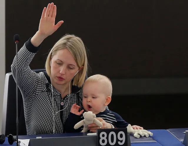 Swedish Member European Parliament Jytte Guteland holds her baby as she takes part in a voting session at the European Parliament in Strasbourg, France, March 14, 2017. (Photo by Vincent Kessler/Reuters)