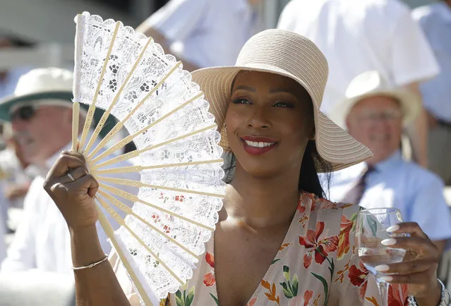 A spectator uses a fan to keep cool ahead of the second day of the test match between England and Ireland at Lord's cricket ground in London, Thursday, July 25, 2019. Weather forecasters predict the UK could encounter the hottest July day on record later Thursday. (Photo by Kirsty Wigglesworth/AP Photo)