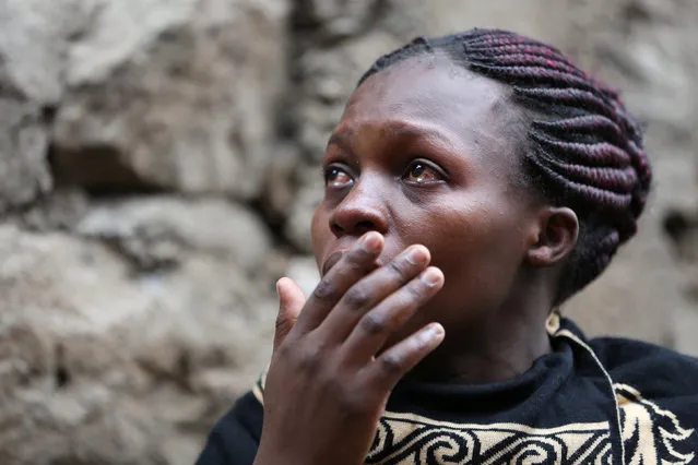 A woman reacts as rescue workers search for residents feared trapped in the rubble of a six-storey building that collapsed after days of heavy rain, in Nairobi, Kenya April 30, 2016. (Photo by Reuters/Stringer)