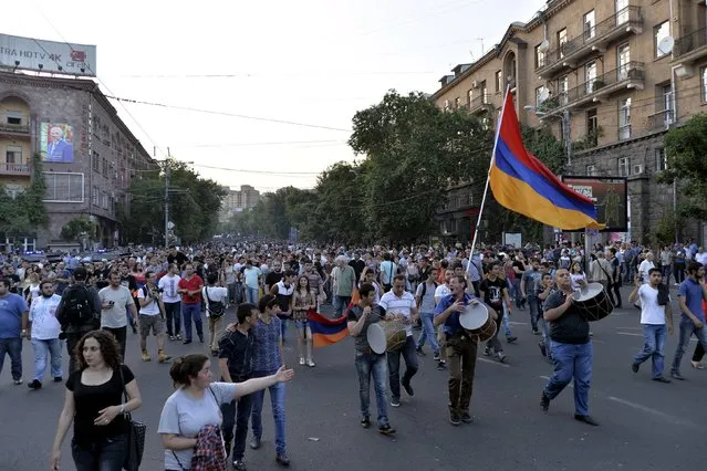 Protesters march during a rally against a hike in electricity prices in Yerevan, Armenia, June 28, 2015. Armenia's president tried to ease days of tension by suspending an increase in public electricity bills, pending a review of the decision, but failed to end a protest by thousands of people. (Photo by Karo Sahakyan/Reuters/PAN Photo)