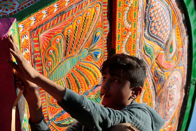 A boy works on the decoration of a truck at a workshop in Rawalpindi, Pakistan February 22, 2017. (Photo by Caren Firouz/Reuters)
