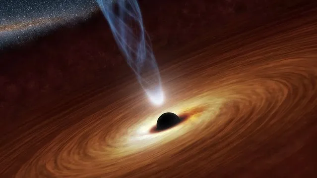 A supermassive black hole with millions to billions times the mass of our sun is seen in an undated NASA artist's concept illustration. In this illustration, the supermassive black hole at the center is surrounded by matter flowing onto the black hole in what is termed an accretion disk. This disk forms as the dust and gas in the galaxy falls onto the hole, attracted by its gravity. (Photo by Reuters/NASA/JPL-Caltech)
