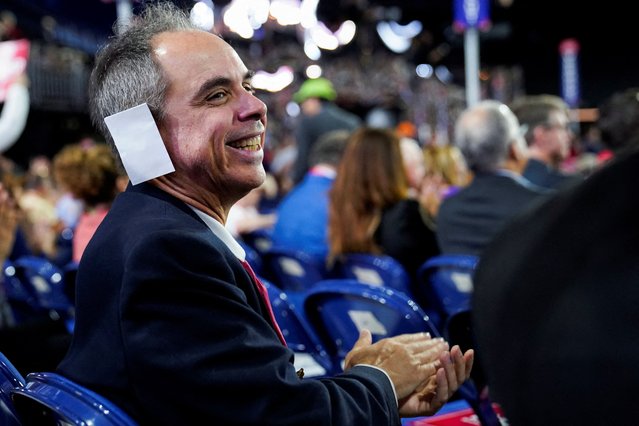 An attendee wears a “bandage” on his ear on Day 2 of the RNC in Milwaukee on July 16, 2024. (Photo by Elizabeth Frantz/Reuters)