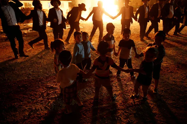 Ultra-Orthodox Jewish boys dance near a bonfire as they celebrate the Jewish holiday of Lag Ba'Omer in the city of Ashdod, Israel May 25, 2016. (Photo by Amir Cohen/Reuters)