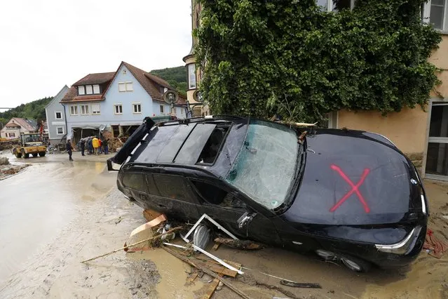 A damaged car is pictured after floods in the town of Braunsbach, Germany, May 30, 2016. (Photo by Kai Pfaffenbach/Reuters)