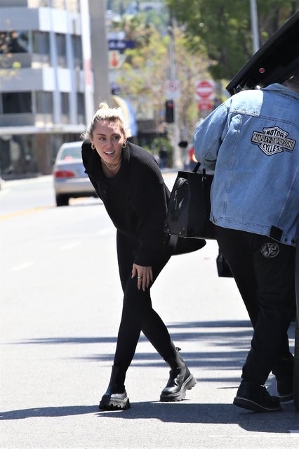 American singer-songwriter Miley Cyrus seen with pals leaving Joan's on Third after picking up some lunch and getting into a Model X Tesla in Los Angeles on April 12, 2022. The pop star wore a black top, matching leggings, and combat boots. (Photo by The Image Direct)