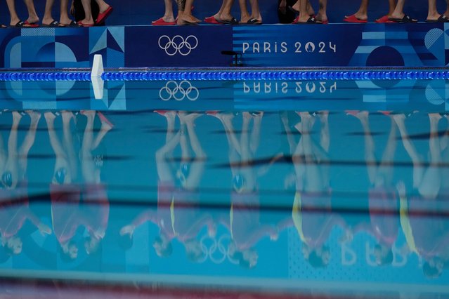 Players from Serbia and Spain are reflected on the pool prior to a men's water polo Group B preliminary match between Serbia and Spain, at the 2024 Summer Olympics, Thursday, August 1, 2024, in Saint-Denis, France. (Photo by Luca Bruno/AP Photo)