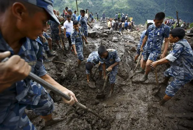Rescue team members search for landslide victims at Lumle village in Kaski district July 30, 2015. (Photo by Navesh Chitrakar/Reuters)