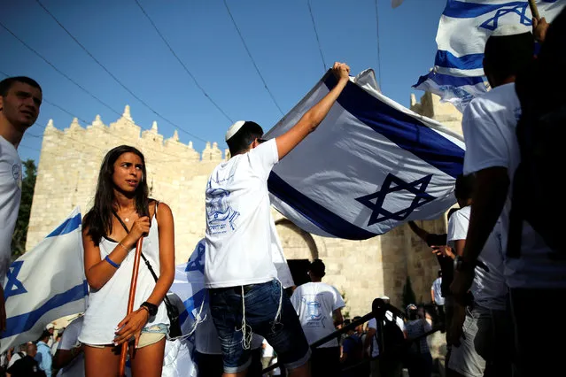 Israelis carry flags during a march marking Jerusalem Day, the anniversary of Israel's capture of East Jerusalem during the 1967 Middle East war, just outside Damascus Gate outside Jerusalem's Old City June 5, 2016. (Photo by Amir Cohen/Reuters)