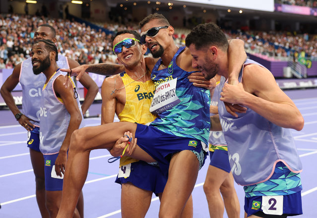 Gold medallist Julio Cesar Agripino dos Santos of Team Brazil celebrates after setting a new World Record of 14:48:85 in the Men's 5000m T11 Final with guides Romario Santos Viana, Micael Batista and Guilherme Ademilson on day two of the Paris 2024 Summer Paralympic Games at Stade de France on August 30, 2024 in Paris, France. (Photo by Ezra Shaw/Getty Images)