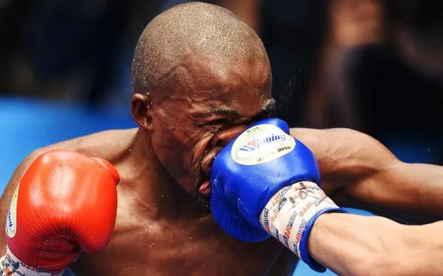 Moruti Mthalane of South Africa is punched by Masayuki Kuroda of Japan during their IBF flyweight title boxing bout in Tokyo on May 13, 2019. (Photo by Charly Triballeau/AFP Photo)