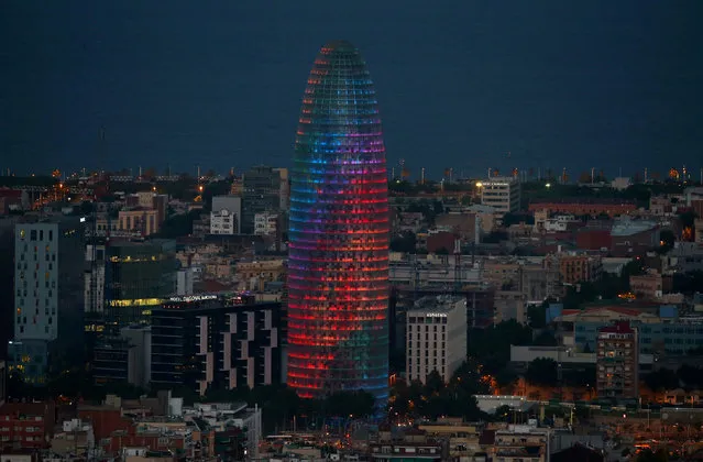 The Agbar tower is illuminated with rainbow colours during World Pride in Barcelona, Spain, June 28, 2017. (Photo by Albert Gea/Reuters)